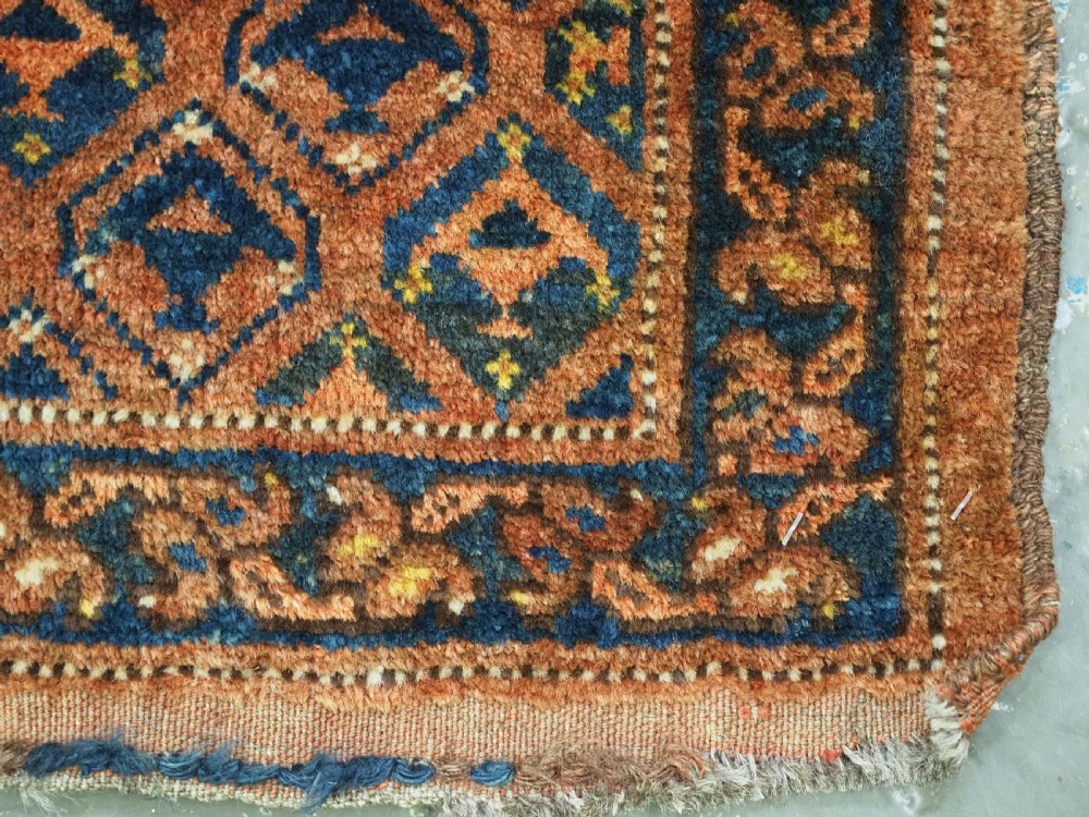 A horizontal antique Ersari Turkmen hand-knotted wool torba face featuring repeated geometric schemle gul motifs in dark blue and terracotta red tones. View XI
