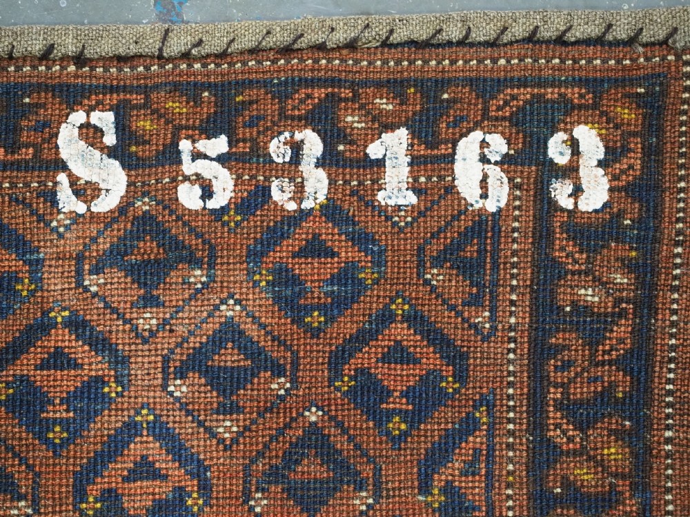 A horizontal antique Ersari Turkmen hand-knotted wool torba face featuring repeated geometric schemle gul motifs in dark blue and terracotta red tones. View XII