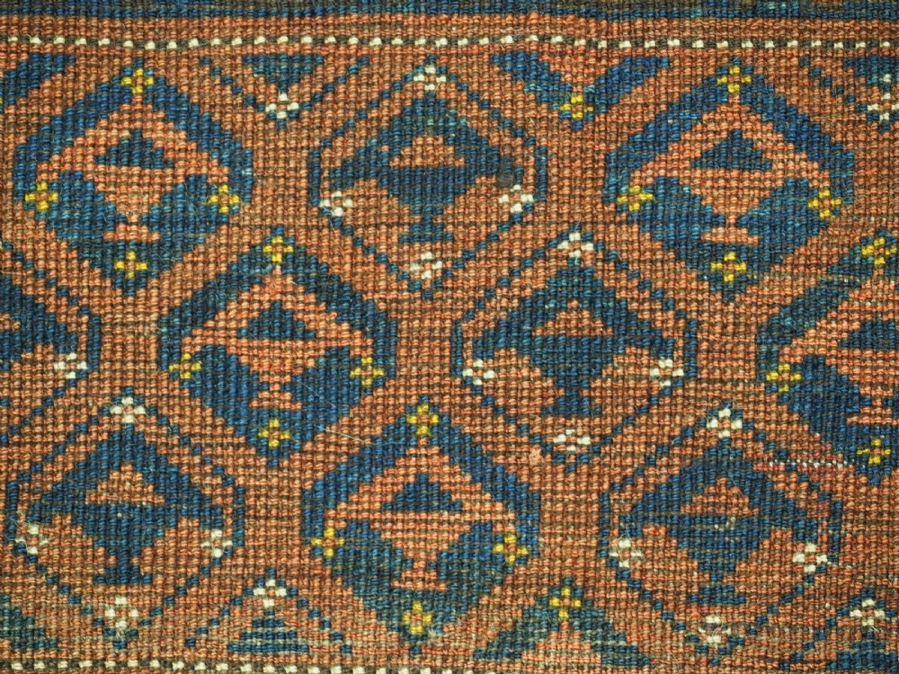 A horizontal antique Ersari Turkmen hand-knotted wool torba face featuring repeated geometric schemle gul motifs in dark blue and terracotta red tones. View XIII