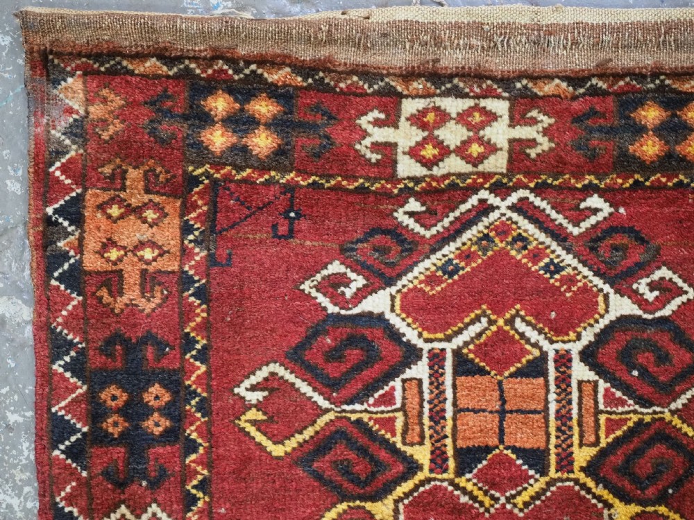 A hand-knotted wool Ersari Turkmen storage bag face featuring a central geometric medallion framed by intricate decorative borders in red, navy blue, yellow, and cream. View II
