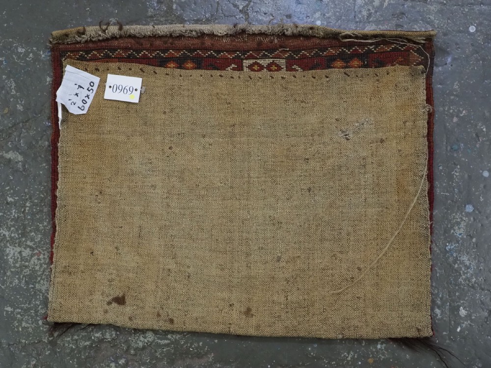 A hand-knotted wool Ersari Turkmen storage bag face featuring a central geometric medallion framed by intricate decorative borders in red, navy blue, yellow, and cream. View VII