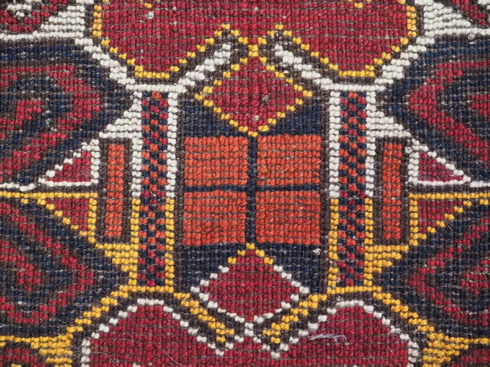A hand-knotted wool Ersari Turkmen storage bag face featuring a central geometric medallion framed by intricate decorative borders in red, navy blue, yellow, and cream. View VIII
