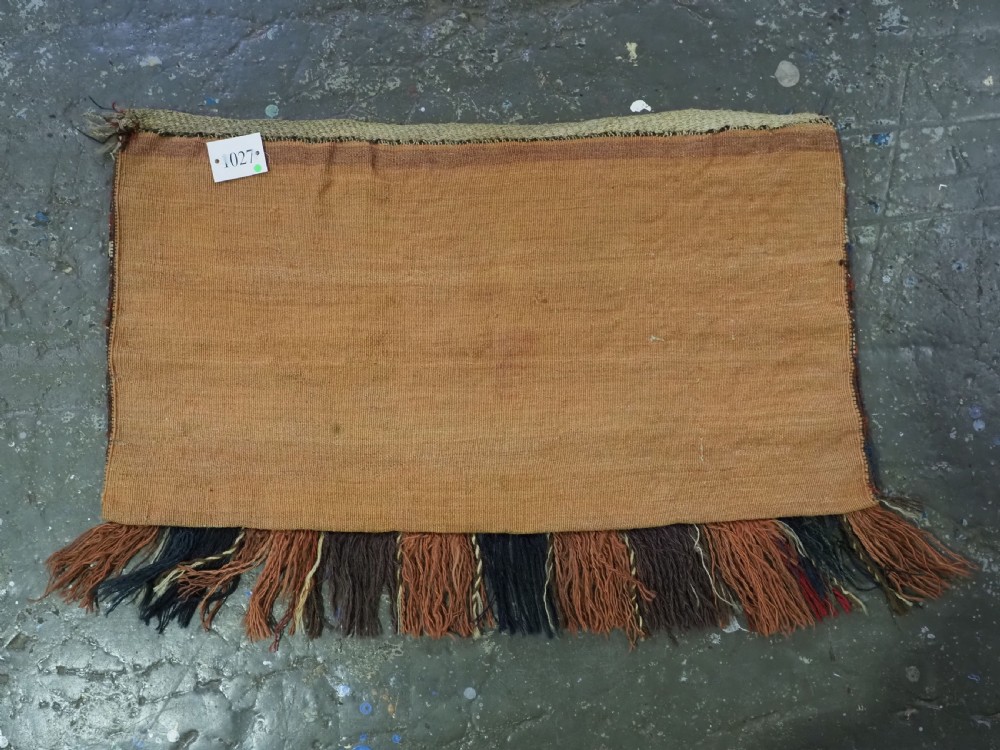 An antique hand-woven Turkmen flatweave textile panel featuring horizontal bands of geometric motifs in terracotta, dark blue, and brown on a cream background with long fringed trim. View IX