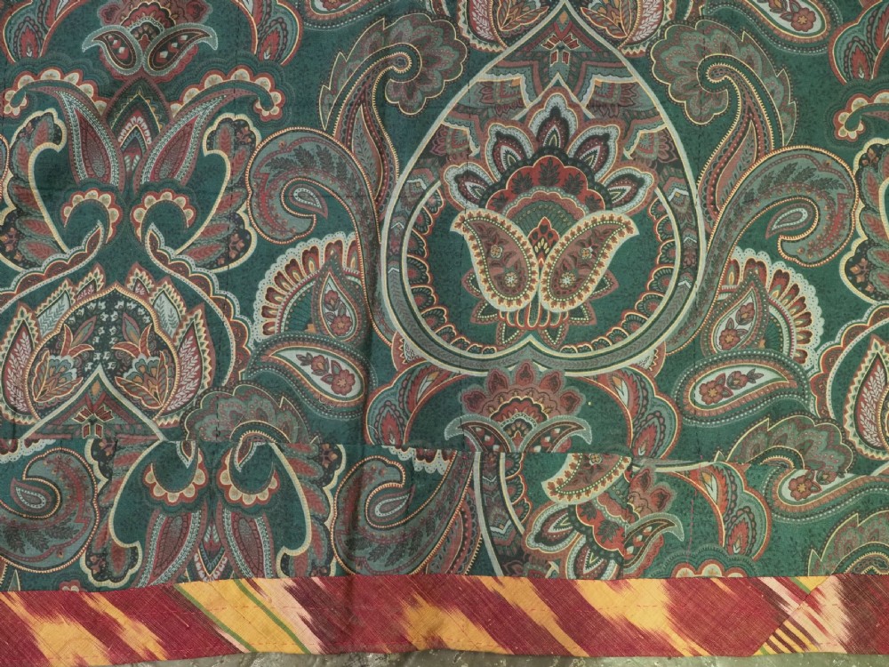 A vertical handwoven silk ikat textile panel featuring bold crimson, yellow, and deep purple circular geometric patterns on an off-white background. View X