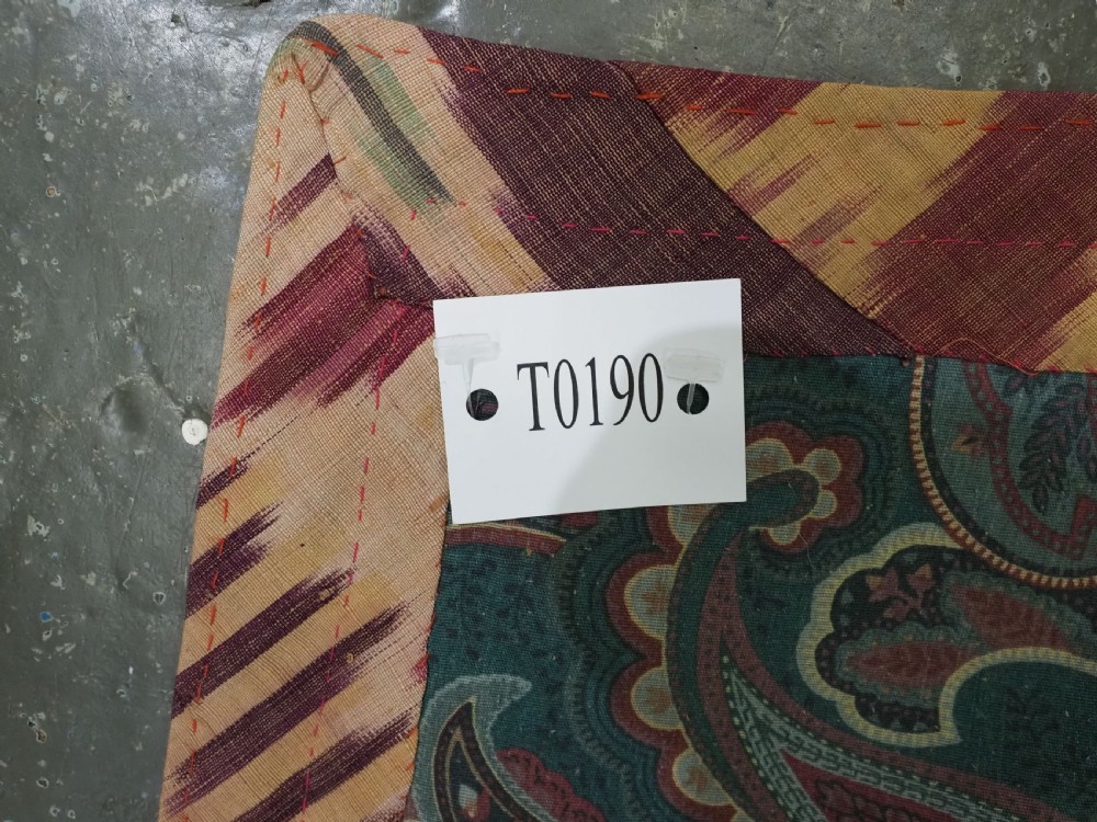 A vertical handwoven silk ikat textile panel featuring bold crimson, yellow, and deep purple circular geometric patterns on an off-white background. View XII
