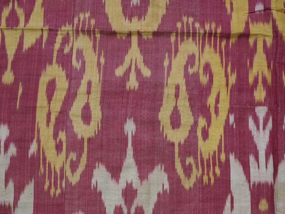 An antique Uzbek silk adras ikat panel featuring bold floral and geometric motifs in crimson red, mustard yellow, and cream. View VIII