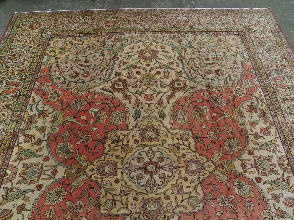 An antique hand-knotted Tabriz carpet featuring a central floral medallion, ornate spandrels, and a multi-tiered border in terracotta, cream, and soft pastel shades. View II