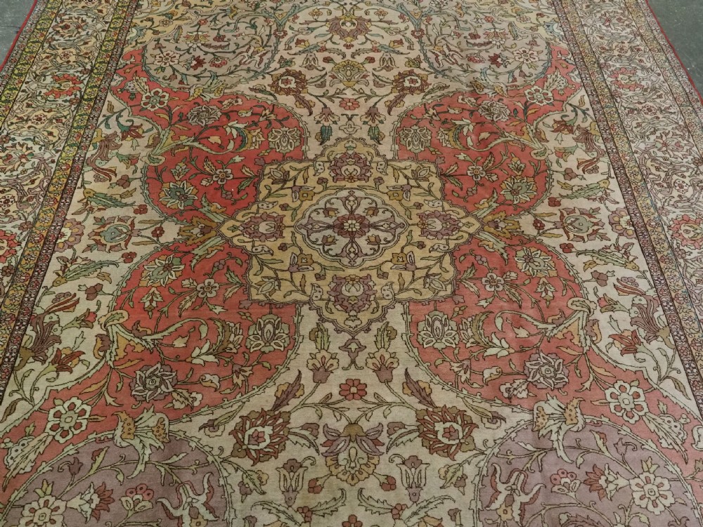 An antique hand-knotted Tabriz carpet featuring a central floral medallion, ornate spandrels, and a multi-tiered border in terracotta, cream, and soft pastel shades. View III