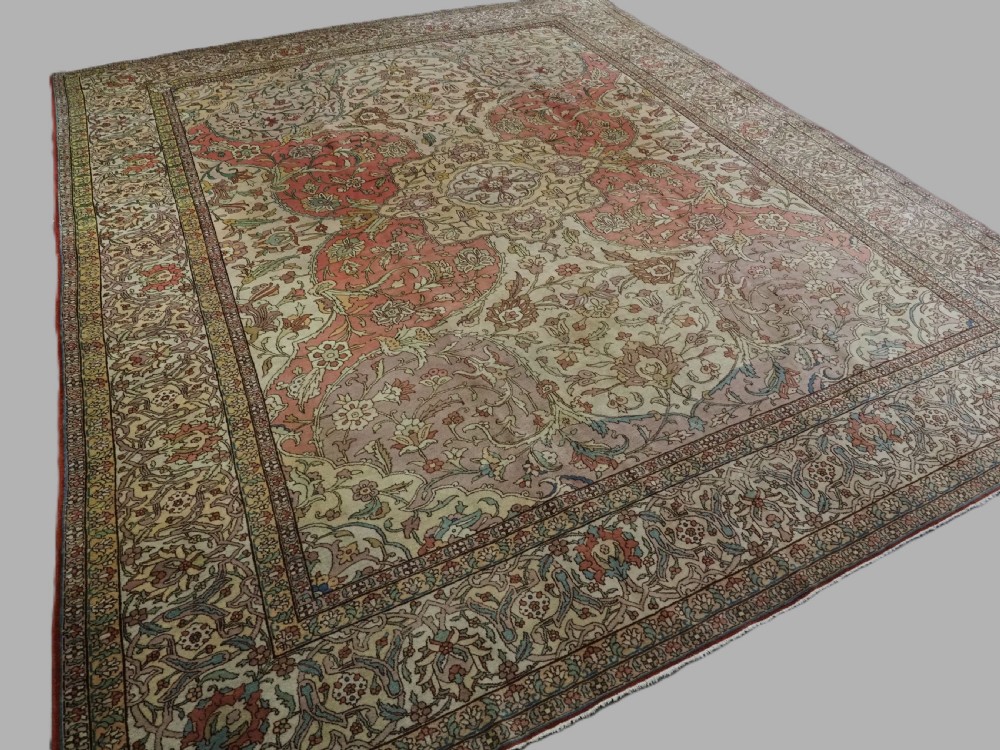 An antique hand-knotted Tabriz carpet featuring a central floral medallion, ornate spandrels, and a multi-tiered border in terracotta, cream, and soft pastel shades. View IV