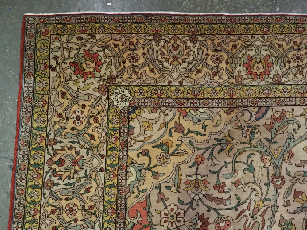 An antique hand-knotted Tabriz carpet featuring a central floral medallion, ornate spandrels, and a multi-tiered border in terracotta, cream, and soft pastel shades. View VI