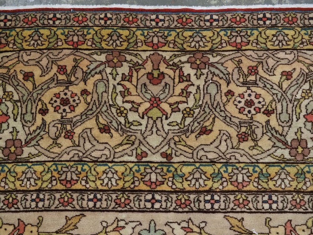 An antique hand-knotted Tabriz carpet featuring a central floral medallion, ornate spandrels, and a multi-tiered border in terracotta, cream, and soft pastel shades. View VII