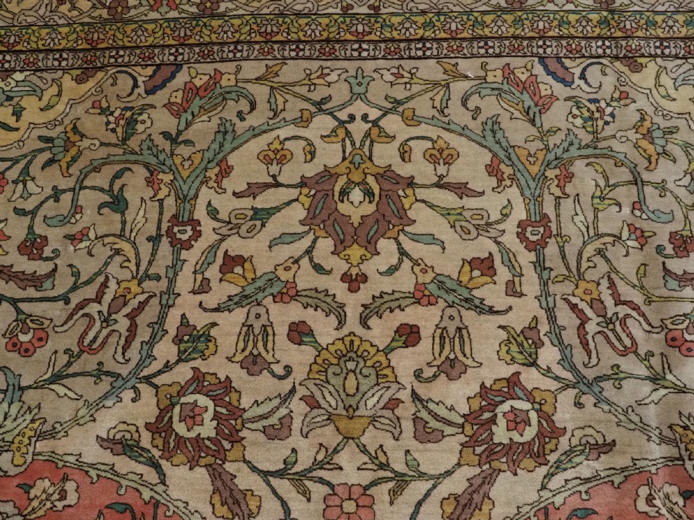 An antique hand-knotted Tabriz carpet featuring a central floral medallion, ornate spandrels, and a multi-tiered border in terracotta, cream, and soft pastel shades. View VIII