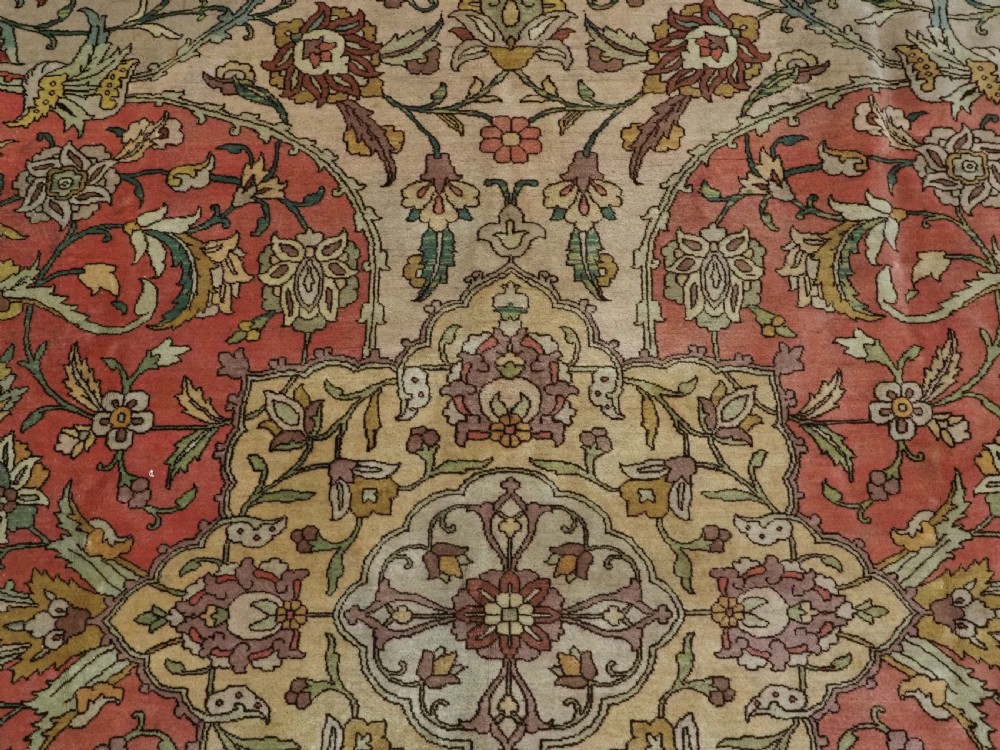 An antique hand-knotted Tabriz carpet featuring a central floral medallion, ornate spandrels, and a multi-tiered border in terracotta, cream, and soft pastel shades. View X