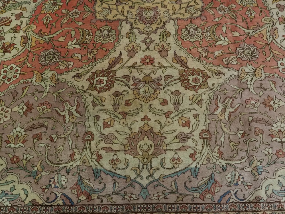 An antique hand-knotted Tabriz carpet featuring a central floral medallion, ornate spandrels, and a multi-tiered border in terracotta, cream, and soft pastel shades. View XII