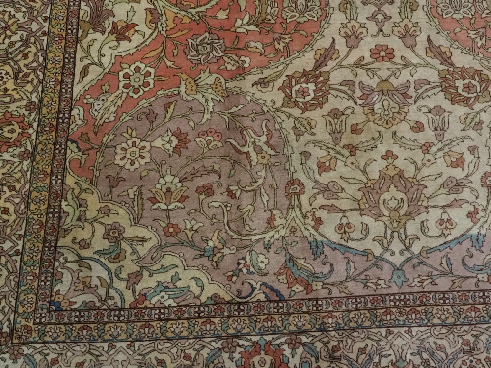 An antique hand-knotted Tabriz carpet featuring a central floral medallion, ornate spandrels, and a multi-tiered border in terracotta, cream, and soft pastel shades. View XIII