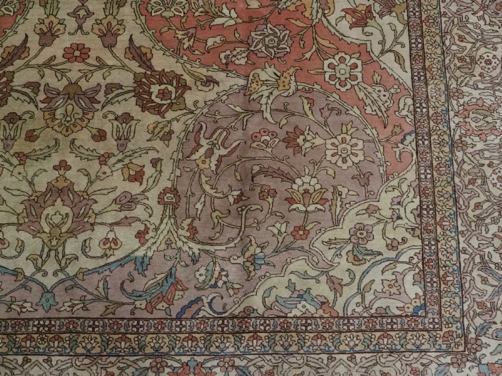 An antique hand-knotted Tabriz carpet featuring a central floral medallion, ornate spandrels, and a multi-tiered border in terracotta, cream, and soft pastel shades. View XIV