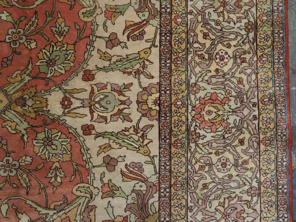 An antique hand-knotted Tabriz carpet featuring a central floral medallion, ornate spandrels, and a multi-tiered border in terracotta, cream, and soft pastel shades. View XV