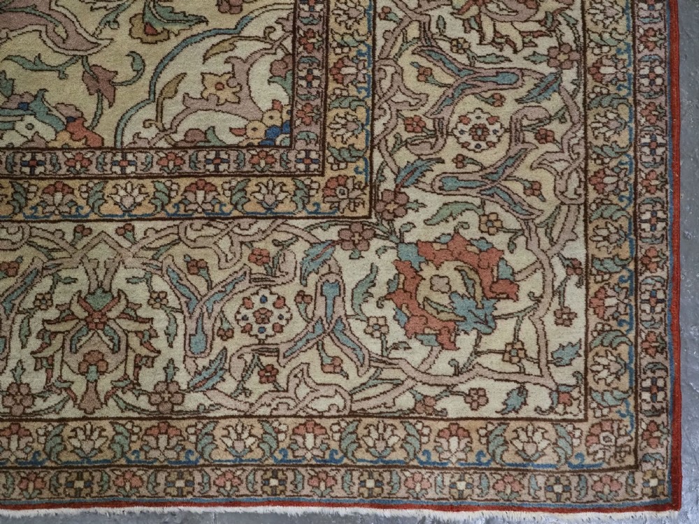 An antique hand-knotted Tabriz carpet featuring a central floral medallion, ornate spandrels, and a multi-tiered border in terracotta, cream, and soft pastel shades. View XVI
