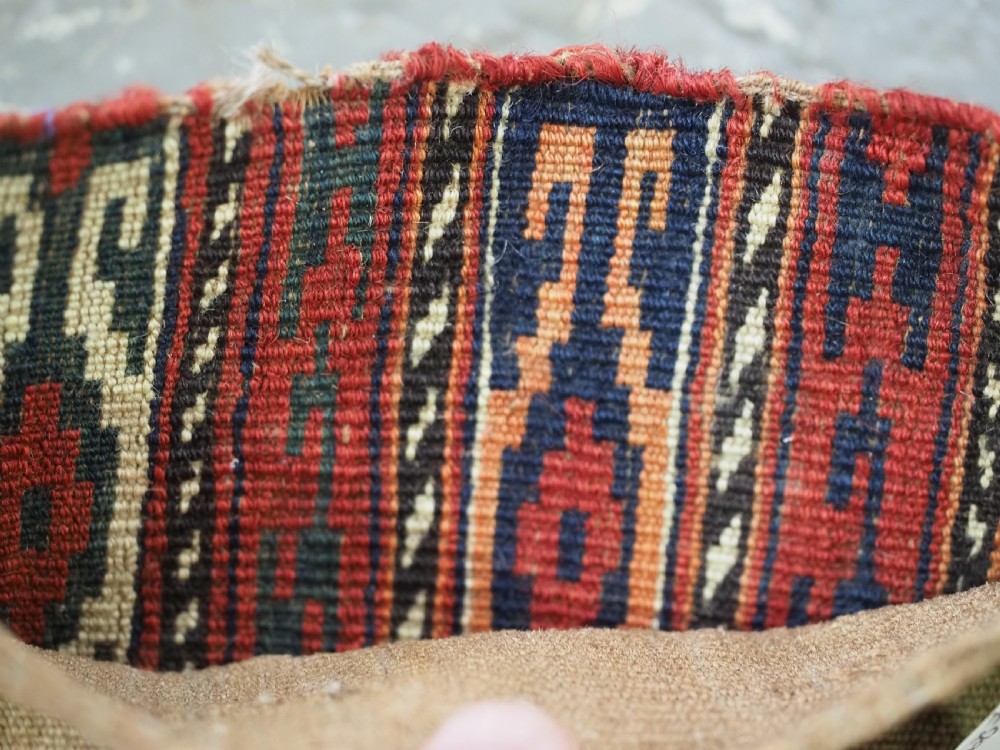 A vertical hand-woven wool Turkmen spindle bag featuring vertical geometric striped patterns in deep red, navy blue, and ivory tones. View VII