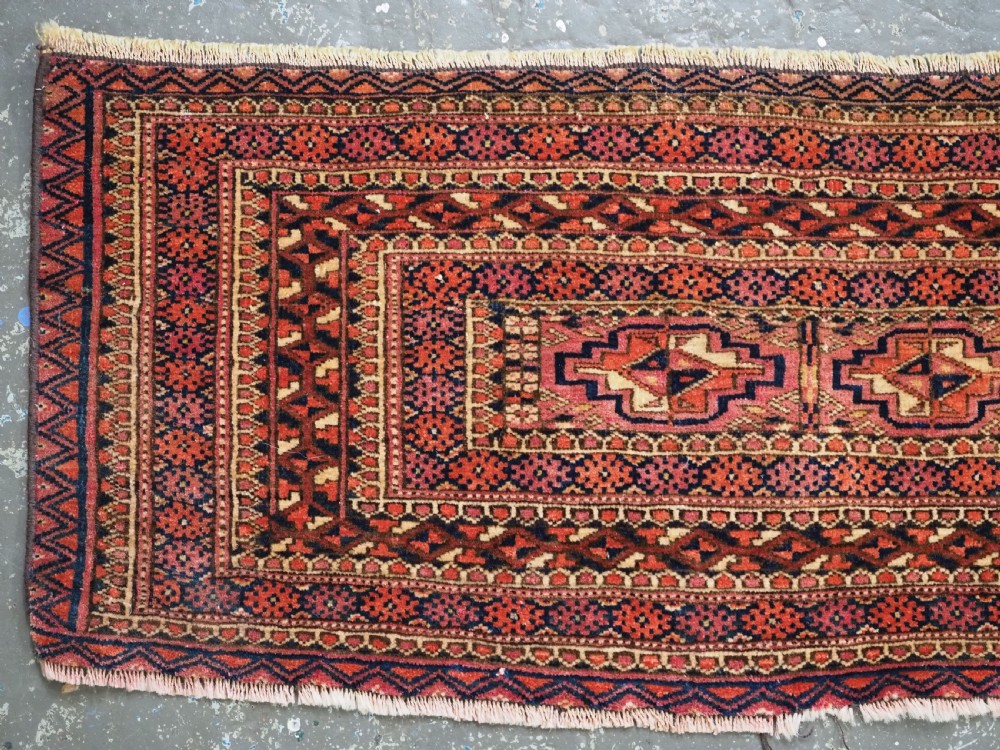 A horizontal hand-knotted wool Tekke Turkmen torba face featuring four central chuval guls enclosed by geometric borders in deep red, navy, and ivory. View II