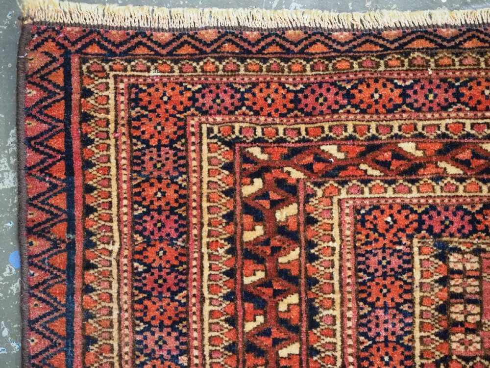 A horizontal hand-knotted wool Tekke Turkmen torba face featuring four central chuval guls enclosed by geometric borders in deep red, navy, and ivory. View IV
