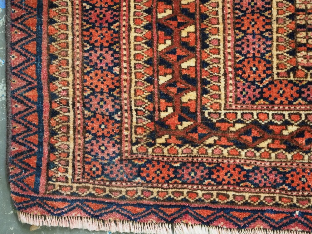 A horizontal hand-knotted wool Tekke Turkmen torba face featuring four central chuval guls enclosed by geometric borders in deep red, navy, and ivory. View V