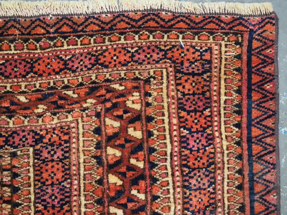 A horizontal hand-knotted wool Tekke Turkmen torba face featuring four central chuval guls enclosed by geometric borders in deep red, navy, and ivory. View IX