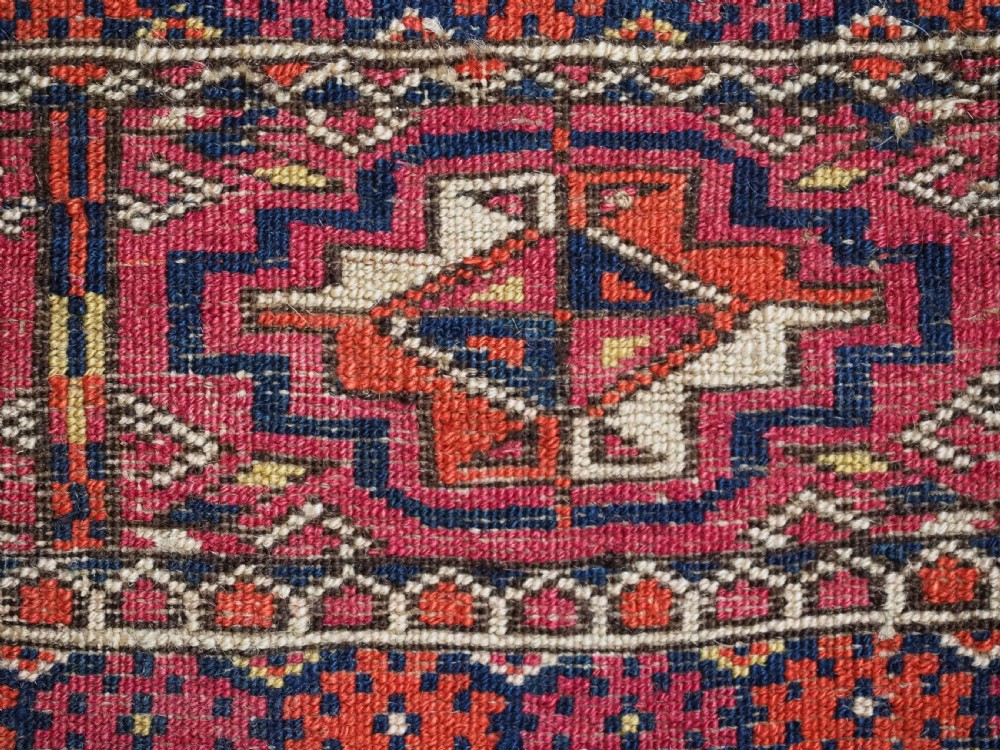 A horizontal hand-knotted wool Tekke Turkmen torba face featuring four central chuval guls enclosed by geometric borders in deep red, navy, and ivory. View XI