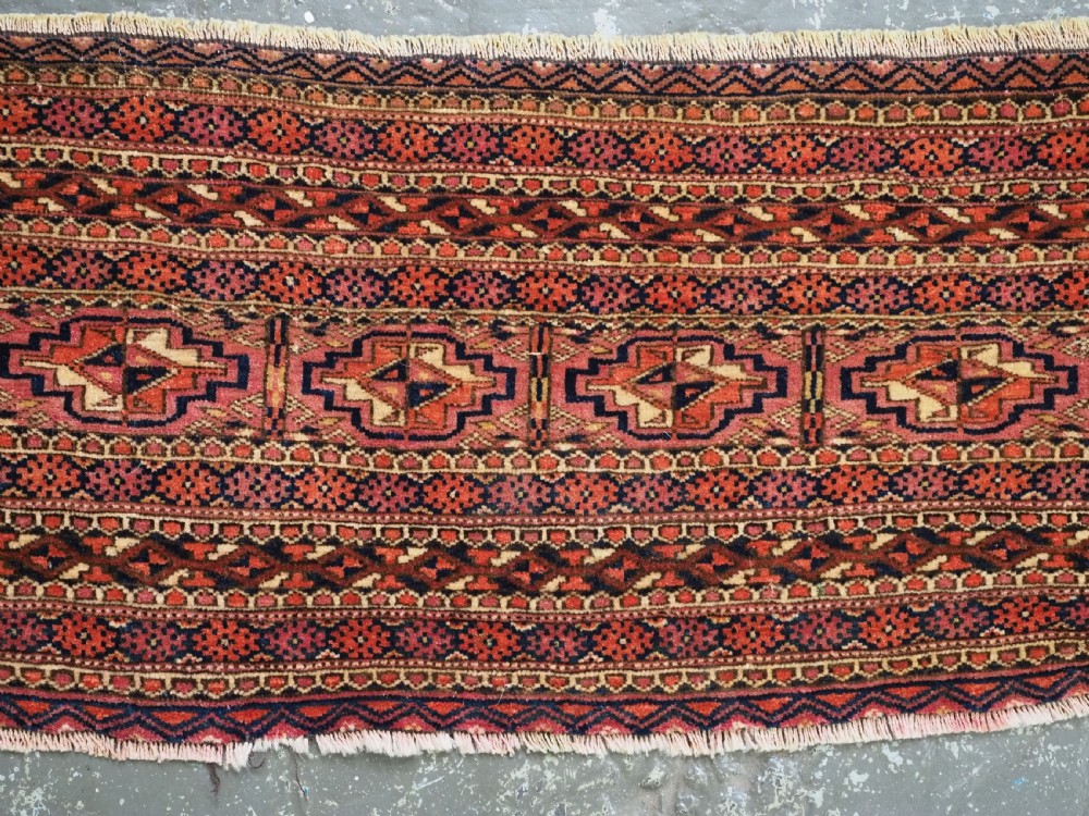 A horizontal hand-knotted wool Tekke Turkmen torba face featuring four central chuval guls enclosed by geometric borders in deep red, navy, and ivory. View XIII