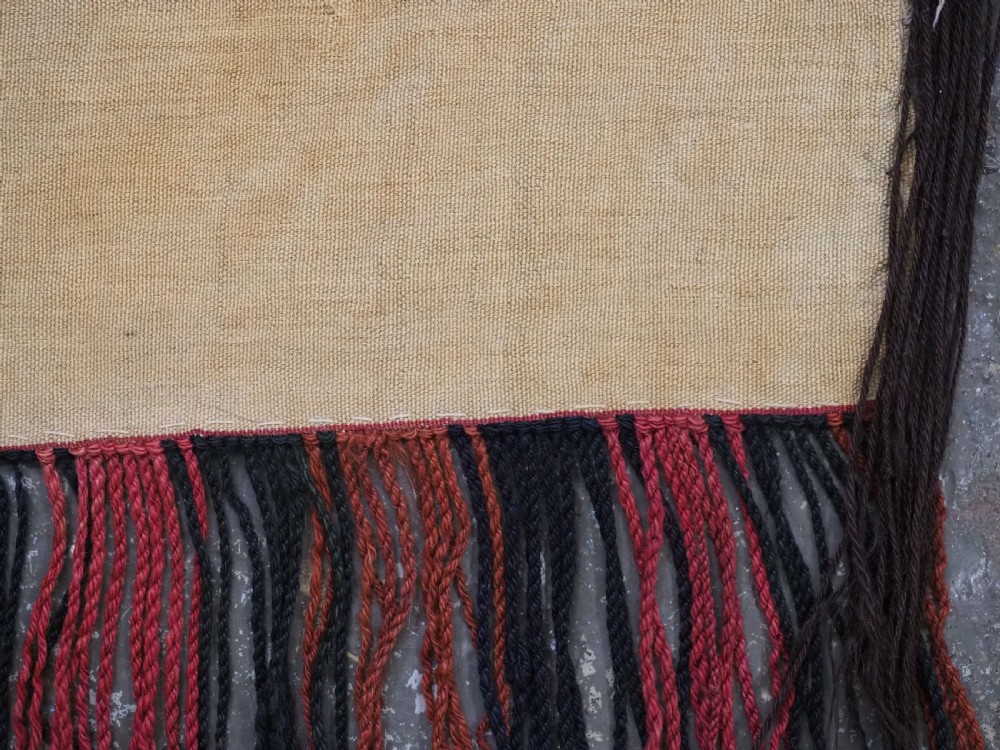 An elongated rectangular Turkmen Ersari torba featuring geometric diamond embroidery in red and dark tones with long fringed tassels along the bottom. View XV