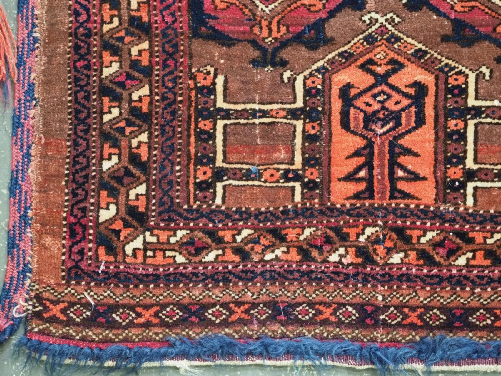 An antique horizontal Saryk Turkmen torba face featuring geometric Kedjebe motifs woven in deep red, dark brown, and cream wool tones. View VII