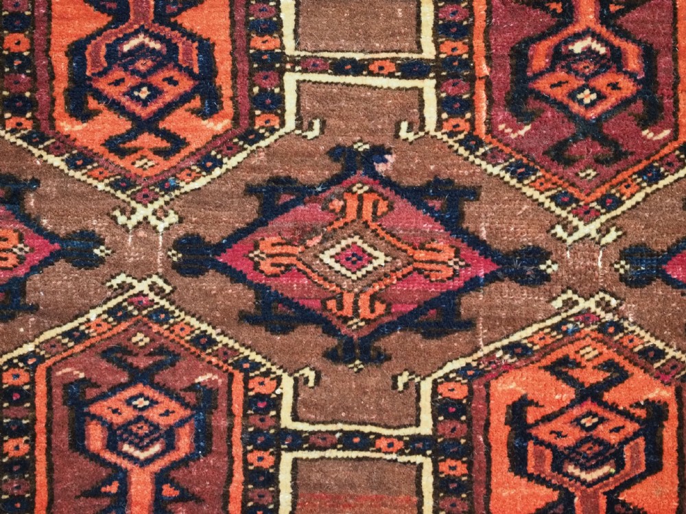 An antique horizontal Saryk Turkmen torba face featuring geometric Kedjebe motifs woven in deep red, dark brown, and cream wool tones. View VIII