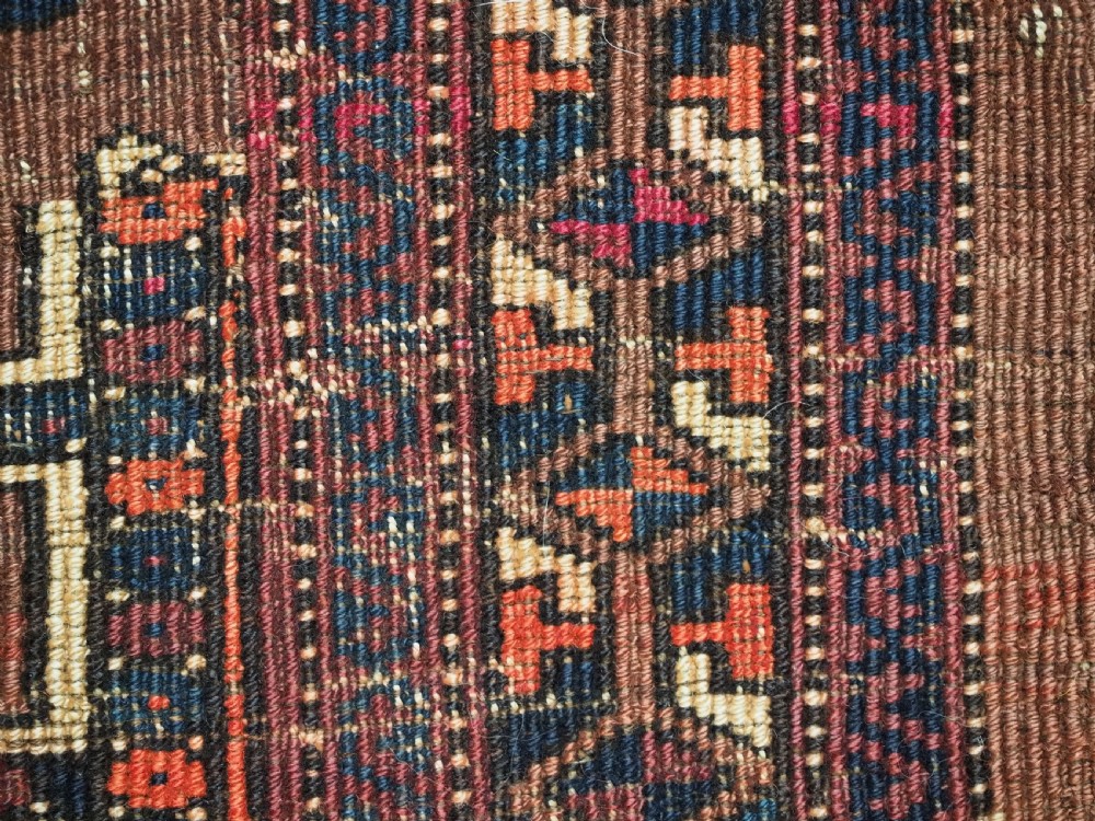 An antique horizontal Saryk Turkmen torba face featuring geometric Kedjebe motifs woven in deep red, dark brown, and cream wool tones. View XI