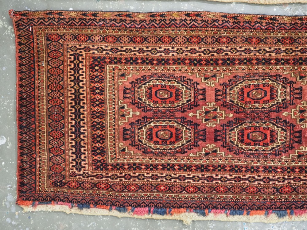A pair of long rectangular hand-knotted dark red wool Tekke Turkmen torba bag faces featuring geometric octagonal Salor guls and detailed patterned borders. View III