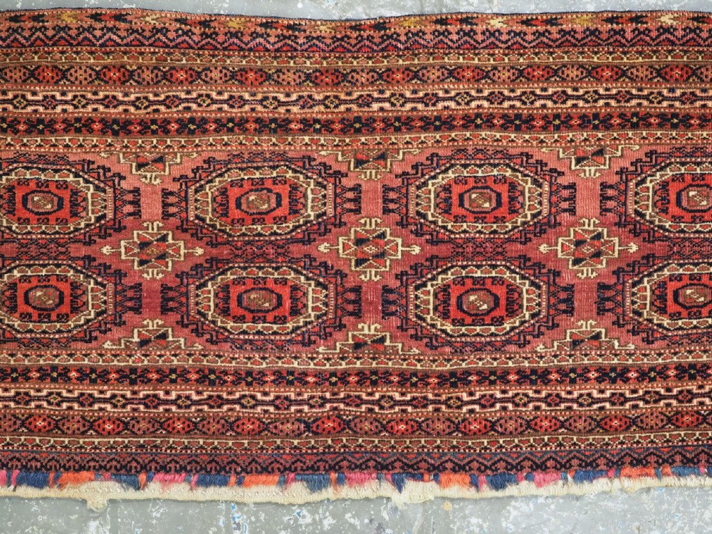 A pair of long rectangular hand-knotted dark red wool Tekke Turkmen torba bag faces featuring geometric octagonal Salor guls and detailed patterned borders. View IV