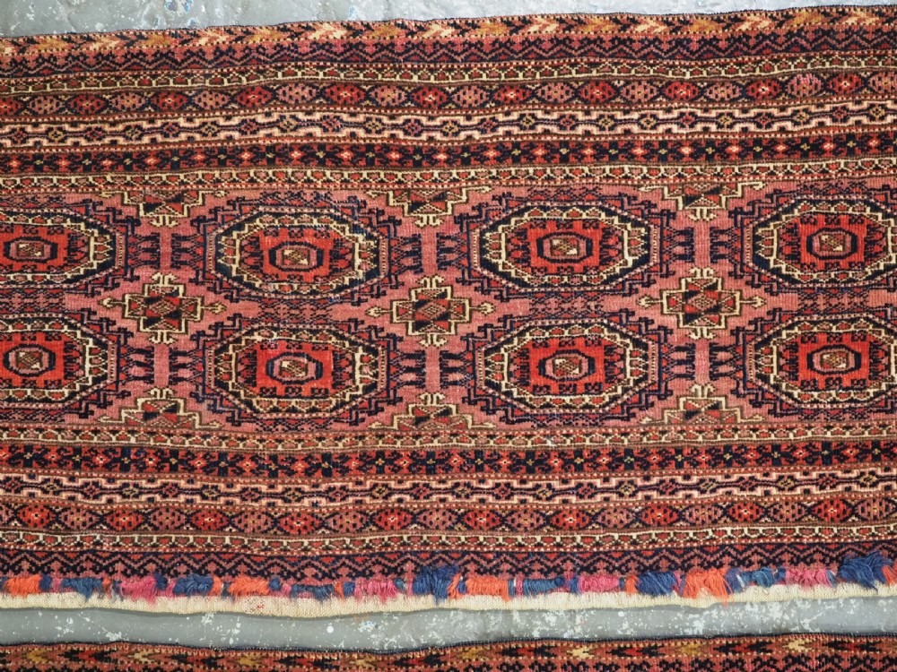 A pair of long rectangular hand-knotted dark red wool Tekke Turkmen torba bag faces featuring geometric octagonal Salor guls and detailed patterned borders. View VI