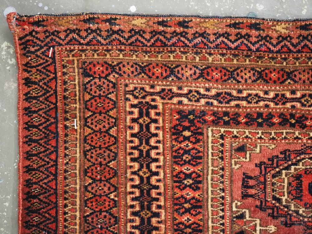 A pair of long rectangular hand-knotted dark red wool Tekke Turkmen torba bag faces featuring geometric octagonal Salor guls and detailed patterned borders. View IX