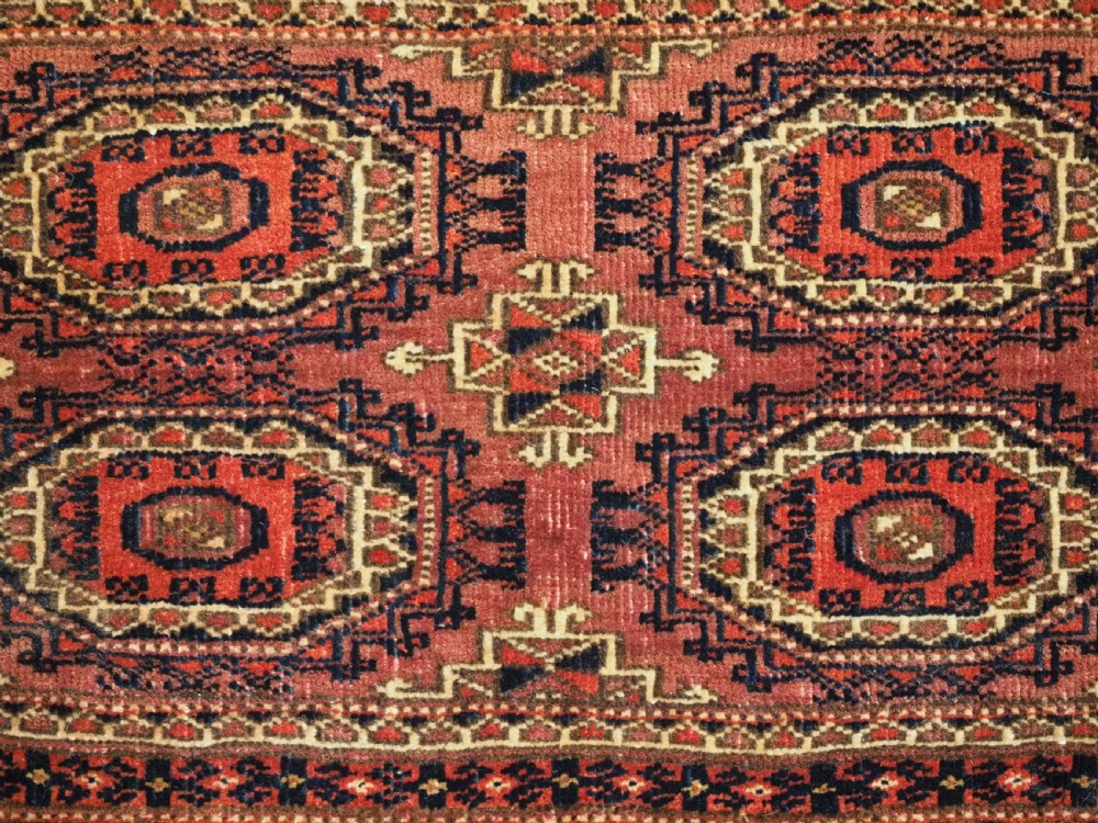 A pair of long rectangular hand-knotted dark red wool Tekke Turkmen torba bag faces featuring geometric octagonal Salor guls and detailed patterned borders. View XI