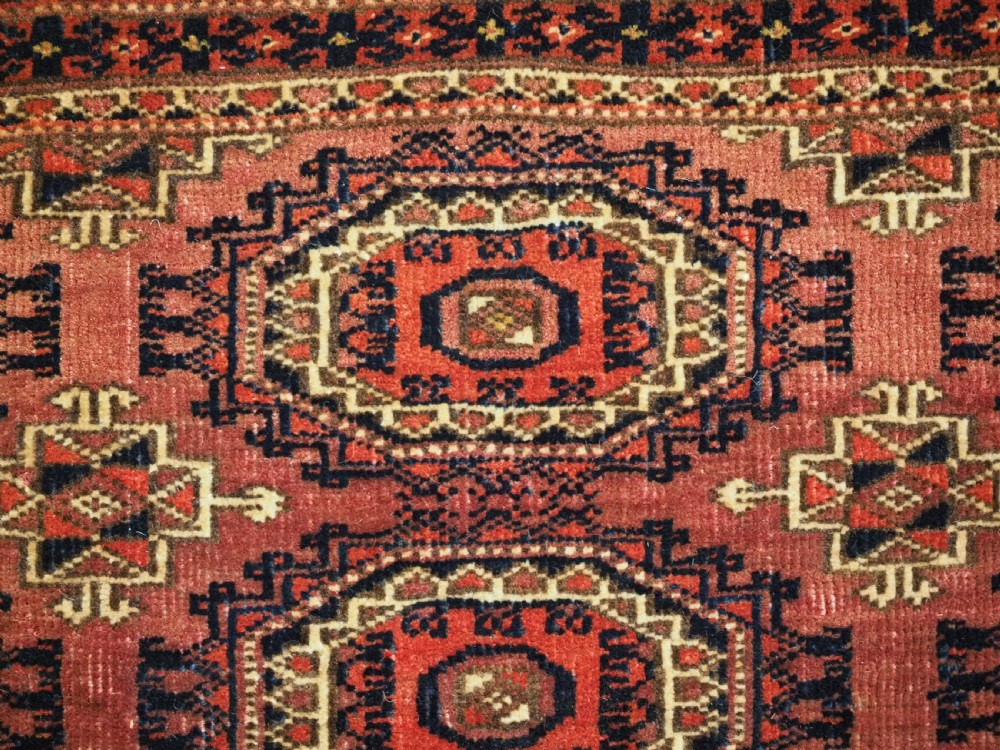 A pair of long rectangular hand-knotted dark red wool Tekke Turkmen torba bag faces featuring geometric octagonal Salor guls and detailed patterned borders. View XII