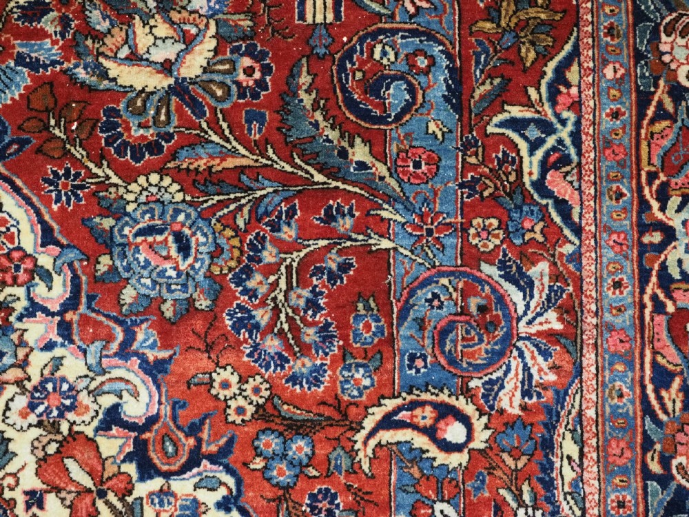 A hand-knotted wool Kashan prayer rug featuring a central floral medallion, a mihrab arch design, and intricate botanical borders in red, navy blue, and cream hues. View XI