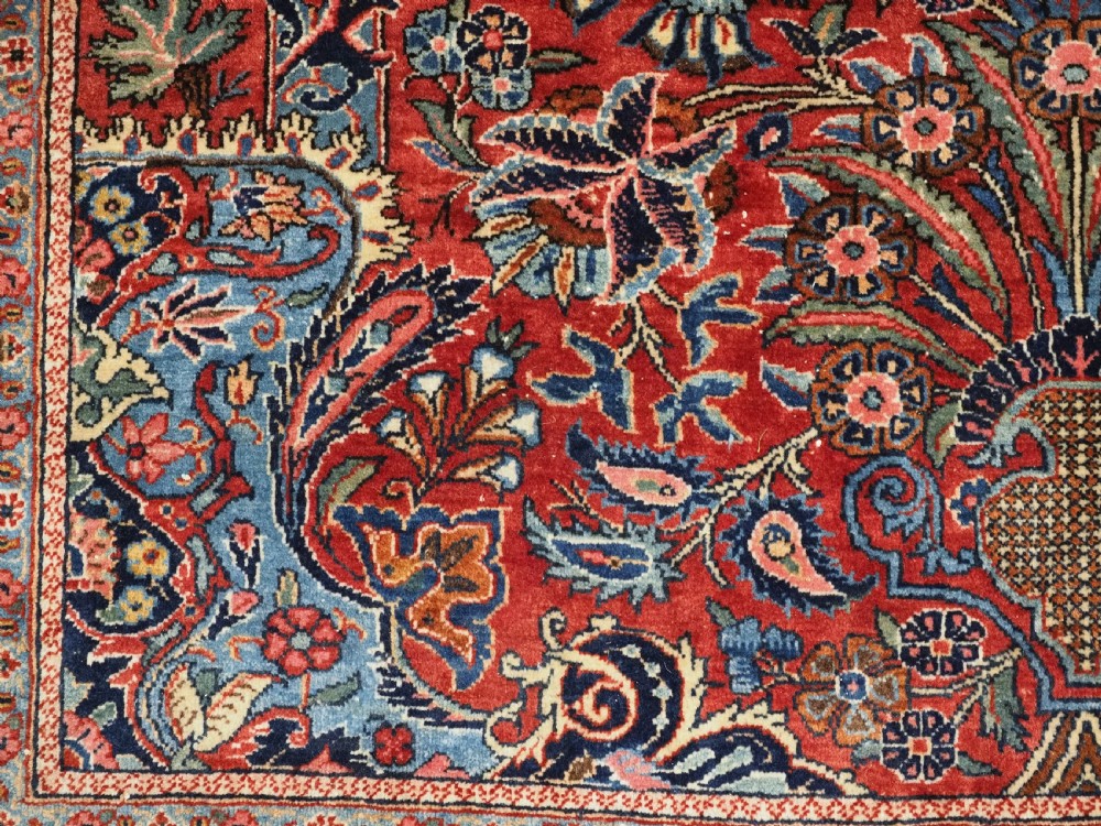 A hand-knotted wool Kashan prayer rug featuring a central floral medallion, a mihrab arch design, and intricate botanical borders in red, navy blue, and cream hues. View XIV
