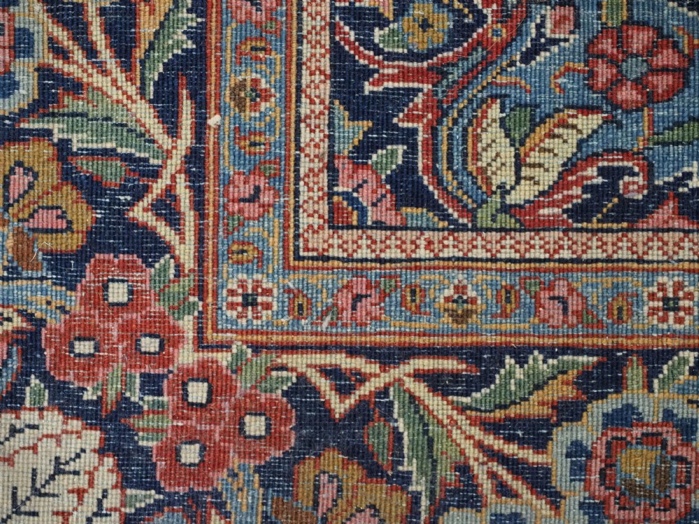 A hand-knotted wool Kashan prayer rug featuring a central floral medallion, a mihrab arch design, and intricate botanical borders in red, navy blue, and cream hues. View XVII