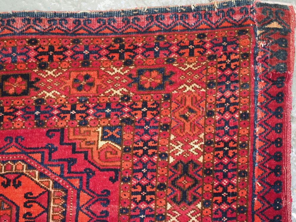 An antique Tekke Turkmen chuval face textile featuring six octagonal turreted guls framed by geometric borders in deep red, navy, and cream wool. View XV