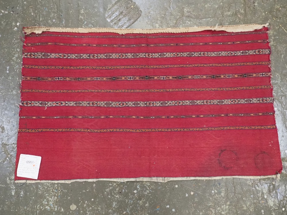 A rectangular red woven Turkmen Tekke chuval face featuring horizontal bands of geometric motifs. View XI