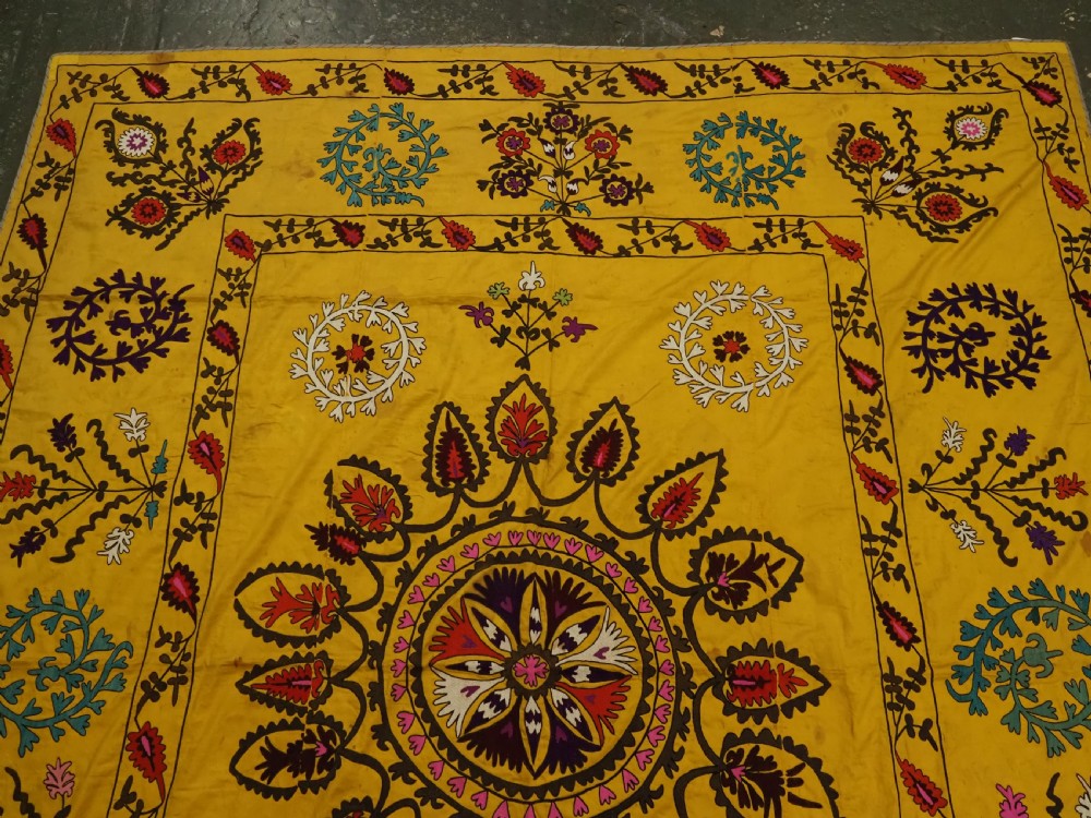 ANTIQUE UZBEK SUZANI, SILK EMBROIDERY ON A YELLOW COTTON GROUND, CIRCA 1900. View III