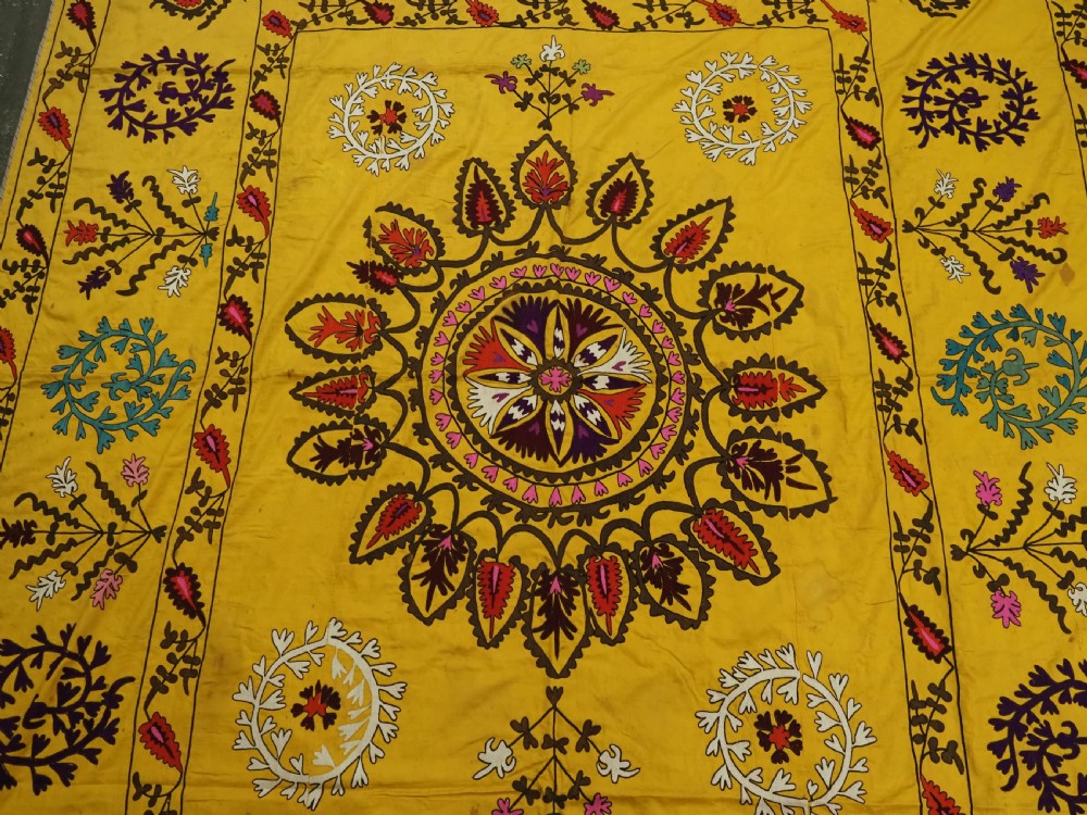 ANTIQUE UZBEK SUZANI, SILK EMBROIDERY ON A YELLOW COTTON GROUND, CIRCA 1900. View IV