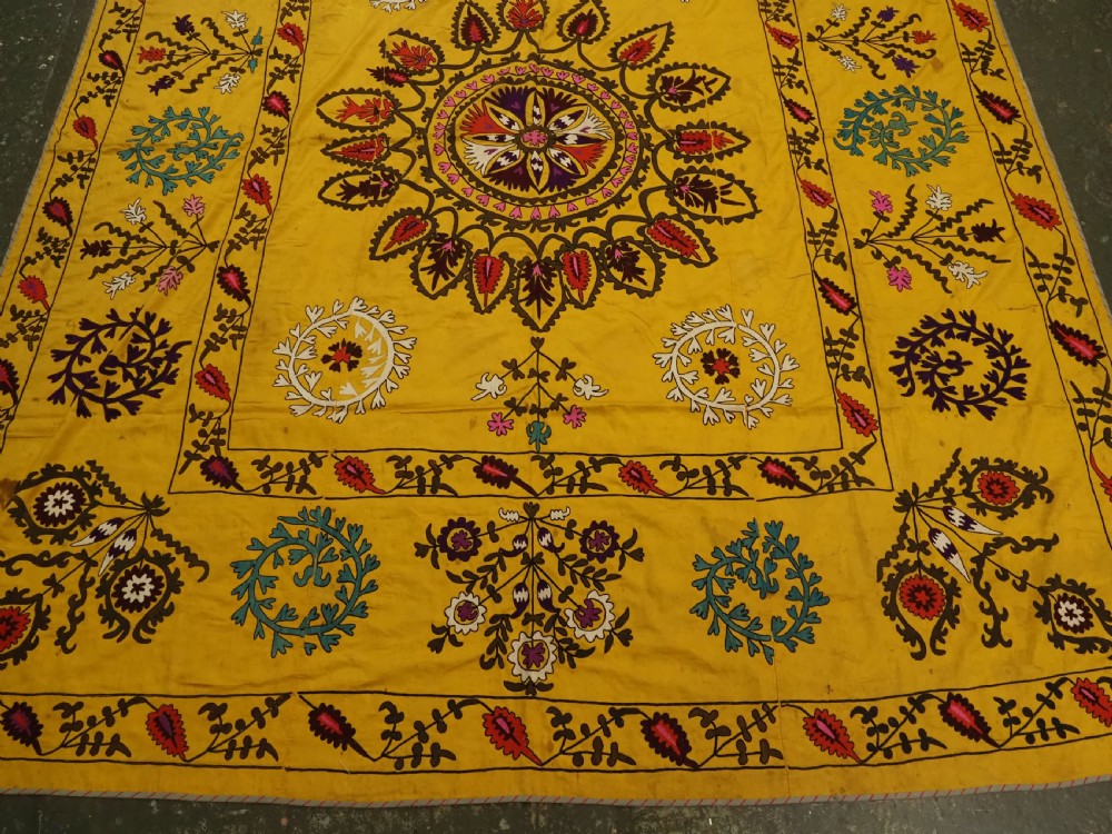 ANTIQUE UZBEK SUZANI, SILK EMBROIDERY ON A YELLOW COTTON GROUND, CIRCA 1900. View V