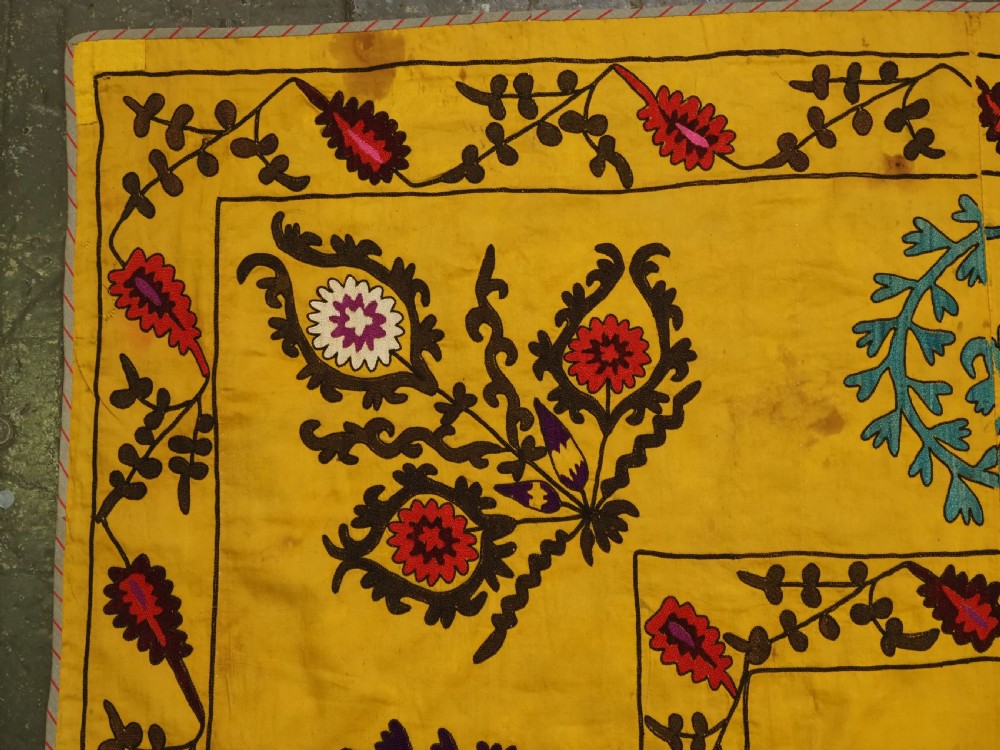 ANTIQUE UZBEK SUZANI, SILK EMBROIDERY ON A YELLOW COTTON GROUND, CIRCA 1900. View VI