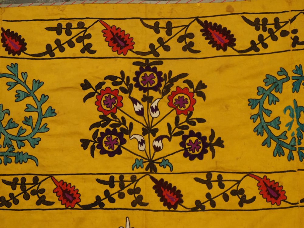 ANTIQUE UZBEK SUZANI, SILK EMBROIDERY ON A YELLOW COTTON GROUND, CIRCA 1900. View VII