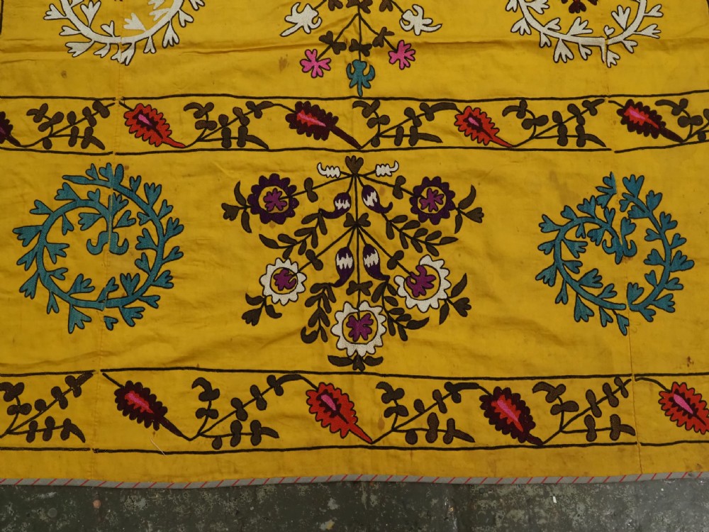 ANTIQUE UZBEK SUZANI, SILK EMBROIDERY ON A YELLOW COTTON GROUND, CIRCA 1900. View IX